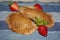 Fresh wholemeal and healthy sweet empanadas stuffed with gold-colored strawberry jam
