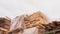 Fresh wooden boards in polypropylene packaging on background of cloudy sky. Stack of industrial natural timber building