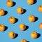 Fresh yellow apples pattern on a pop light blue background. Isometric view with hard light. Bio juices concept