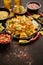 Fresh yellow corn nacho chips on ceramic plate