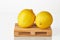 Fresh yellow lenons on logistic pallet waiting for transportation to destination place isolated over white background. Fruits