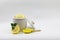 Fresh yellow sliced lemon scrub and crystal sugar rock candy mint and leaf in a white cup jar isolated white background