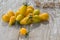 Fresh yellow small pear tomatoes on a sunny day in a wooden table. Delicious food. Vegetarian concept