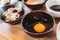 Fresh yolk and white egg in ceramic bowl for dipping with boiled Shabu beef