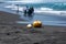 Fresh young coconut on the dark sandy beach in Pantai Dewa Ruci Purworejo, Indonesia