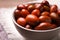 Fresh Ziziphus jujuba fruits in bowl on table, closeup