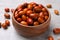 Fresh Ziziphus jujuba fruits in wooden bowl on light table, closeup