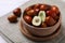 Fresh Ziziphus jujuba fruits in wooden bowl on table, closeup