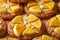 Freshly Baked Almond Cookies Topped with Sliced Mango and White Chocolate Shavings Close Up