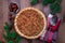 Freshly baked American apple cranberry pie, topped with crumbled dough and pecan, top view