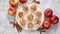 Freshly baked apple roses cakes served on white plate, flat lay