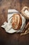 Freshly baked Artisan sourdough bread loaves with wheat spike and bag of flour on dark wooden background