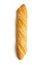 Freshly baked artisan whole baguette with golden crusty floury texture accurately isolated with light shadow on white background