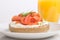 Freshly baked bagel with cream cheese, lox and orange juice