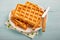 Freshly baked belgium waffles in plate. Breakfast concept with c