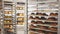 Freshly baked bread, loaves and rolls on tray rack trolley in bakery workshop