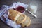 Freshly baked bread served with jam and glass of milk.