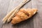 Freshly baked butter croissant on wooden table