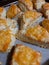 Freshly baked cheese scones close up on parchment paper