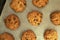 Freshly baked chewy oatmeal raisin cookies on a baking sheet
