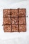 Freshly baked chocolate chewy brownie, cut into nine square pieces