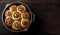 Freshly Baked Cinnamon Rolls in a Pan on Wooden Table, Copy Space