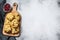 Freshly baked cranberry oatmeal cookies on wooden cutting board. White background. Top view. Copy space