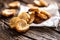 Freshly baked crispy bake rolls with goldish colour served in the paper on a rustic wooden desk