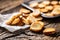 Freshly baked crispy bake rolls with goldish colour served in the paper on a rustic wooden desk