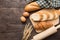 Freshly baked croissants, baguette and eggs on wooden background