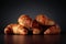 Freshly baked croissants on a black ceramic table