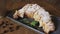 Freshly baked croissants, mint leaves and cup of coffee on wooden board, top view, selective focus