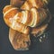 Freshly baked croissants with raspberry jam in jar, square crop