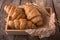 Freshly baked croissants on wooden boards, with wheat eart.