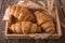 Freshly baked croissants on wooden boards, with wheat eart.