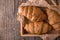 Freshly baked croissants on wooden boards, with wheat eart.