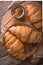 Freshly baked croissants on wooden boards, with wheat eart.