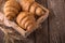 Freshly baked croissants on wooden boards, with wheat eart.