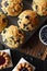 Freshly baked crumble muffins and cakes with wild bilberries on oak cutting board copy space. Low key still life with natural