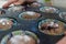 Freshly baked cupcake cakes in two varieties in muffin tin, one standing outside, selected focus, narrow depth of field