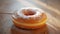 Freshly baked donut on wooden table, a sweet indulgence