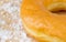 Freshly baked donuts with icing sugar on wooden background.