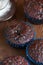 Freshly baked double chocolate muffins on a wooden background wi