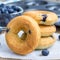 Freshly baked doughnuts with blueberries for breakfast, square