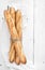 Freshly baked French baguettes on white wooden