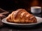 Freshly baked French croissant for breakfast with coffee