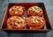 Freshly baked French raisin buns. Pains aux raisins on a vintage baking tray