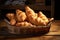 Freshly baked golden croissants in a woven basket on a wooden table