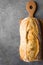 Freshly Baked Hand Crafted Rustic Bread Loaf on Cutting Board Dark Stone Background. Authentic Rustic Style. Food Bakery Poster