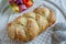 Freshly baked Home made sweet braided bread on a wooden board